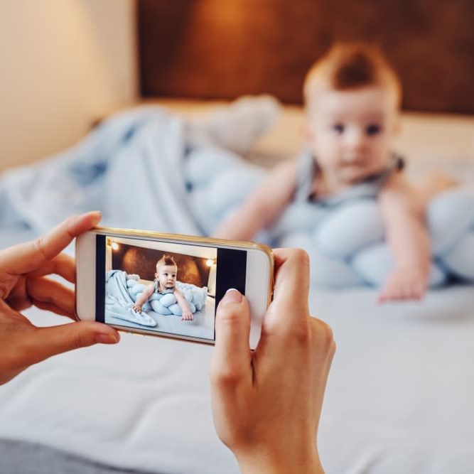 Mother,Taking,Photo,Of,Her,Adorable,Baby,Boy.,Baby,Lying